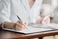A person writing notes