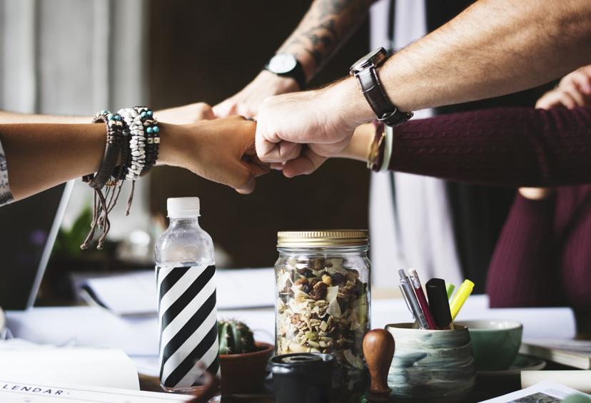 A group of people fist bumping
