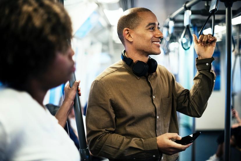 Man on bus holding phone