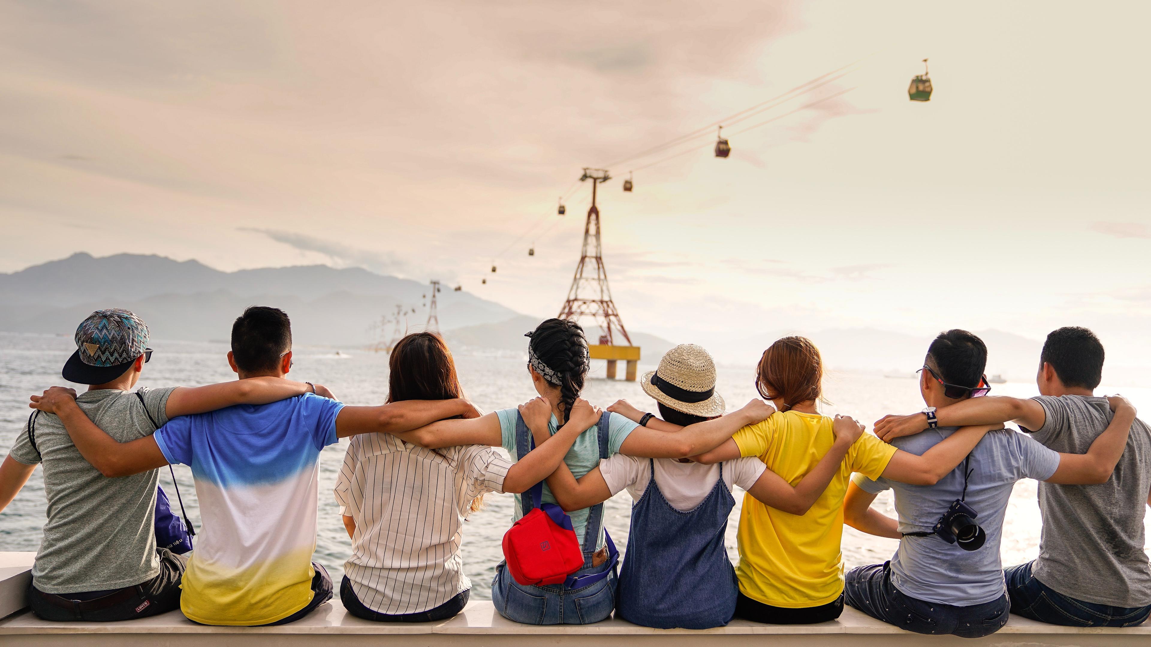 Group of peple in a row looking at a view.