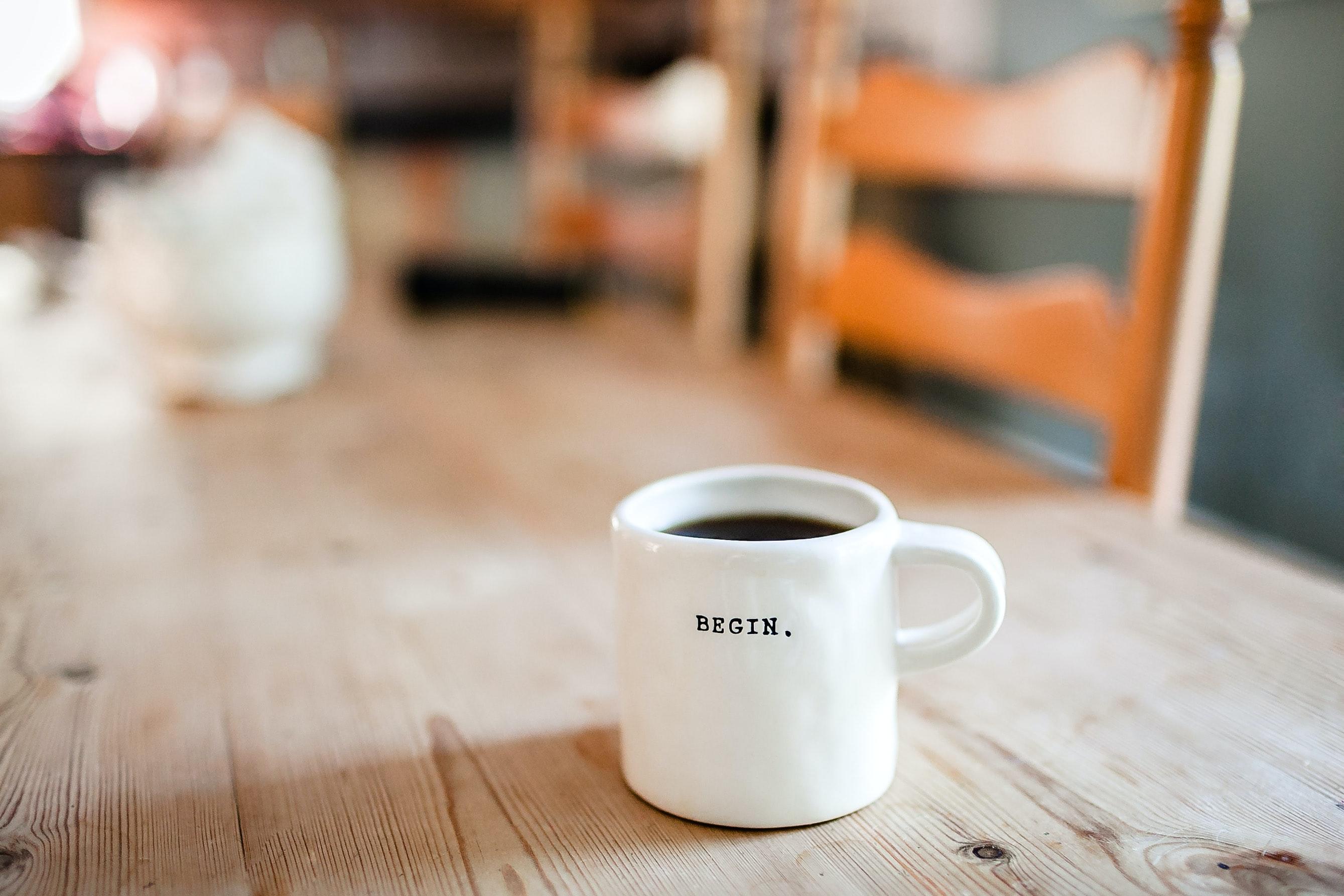 A coffee cup with the word begin written on the side
