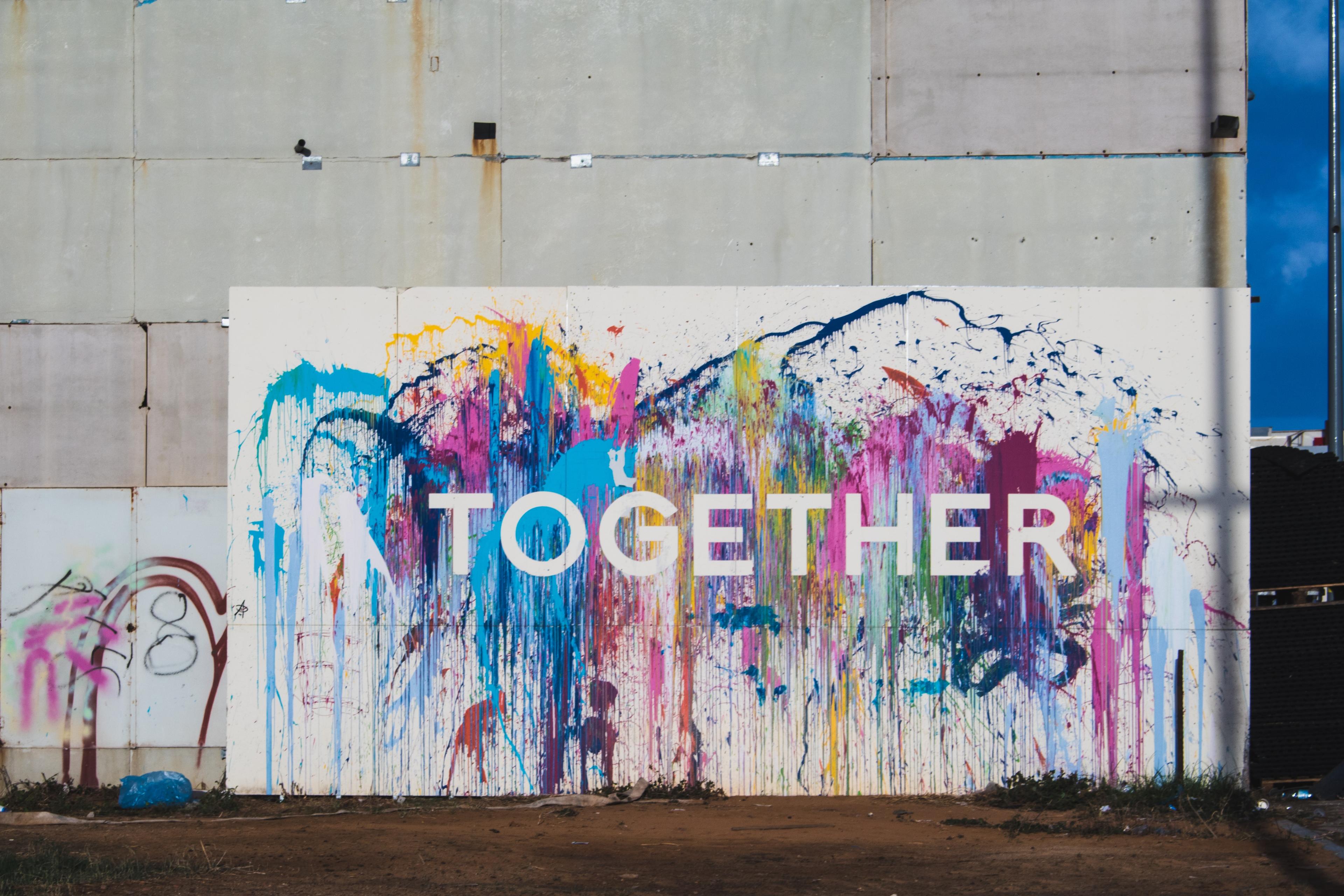 A graffiti wall with the words together