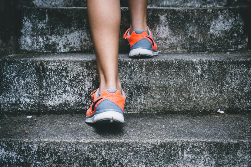 Woman in trainers walking up steps