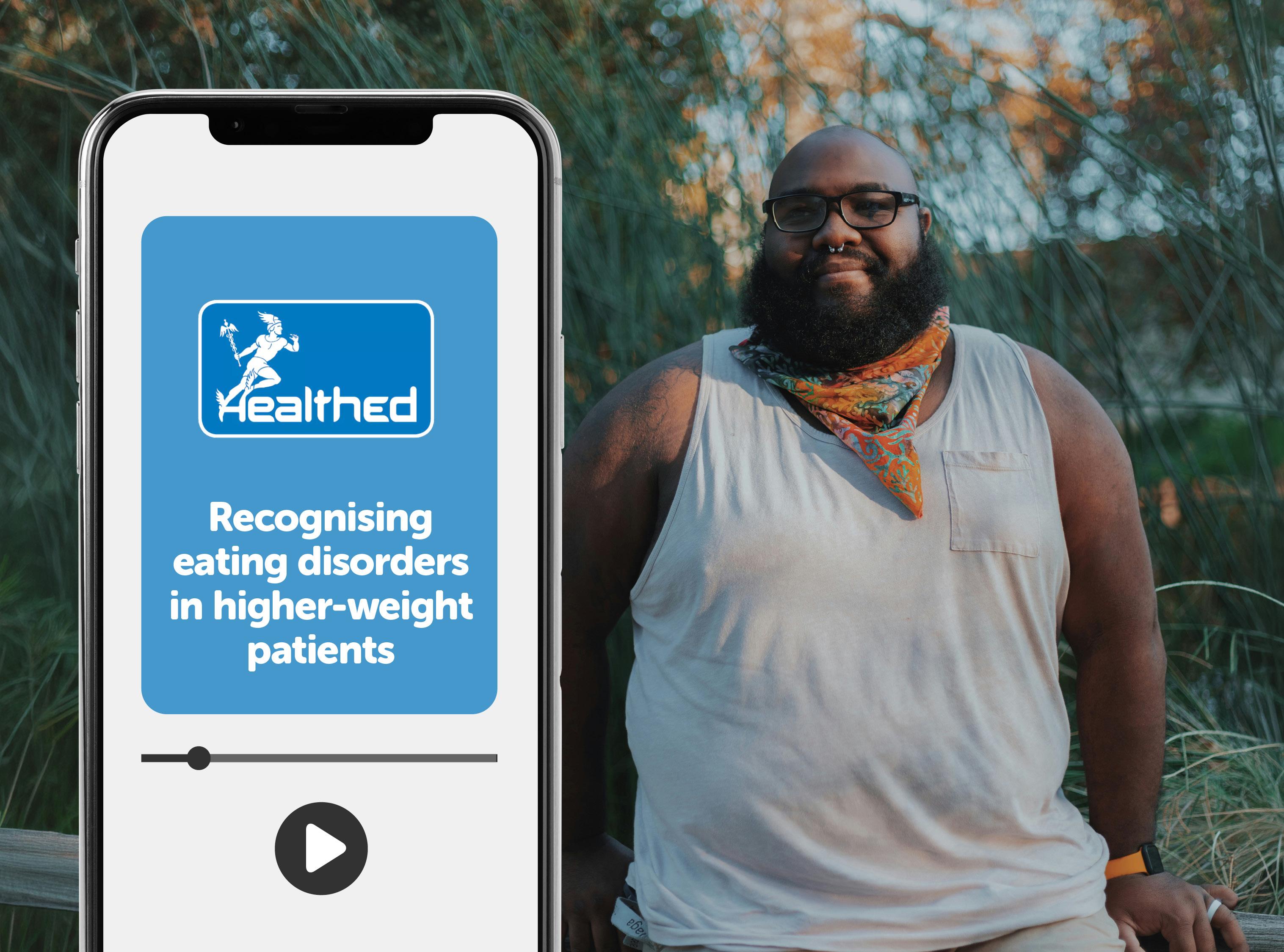 Smartphone displaying a Healthed educational video titled “Recognising eating disorders in higher-weight patients.” A video progress bar and play button appear on the phone screen. In the background, a person wearing glasses and a sleeveless top stands outdoors among tall grasses and trees.